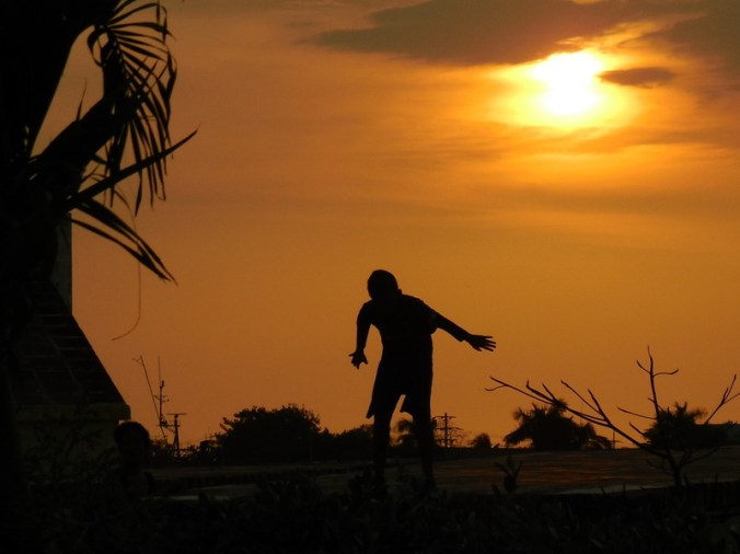 Kid mucking at sunset 3